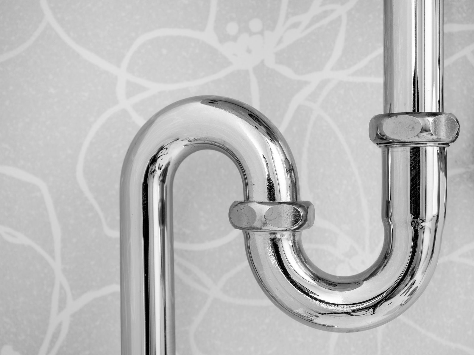 Chrome P-trap drain pipe under a bathroom sink