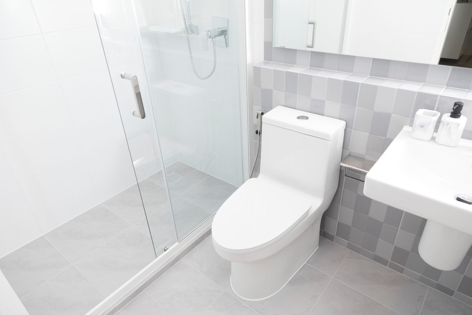 Bright bathroom with toilet, sink and glass shower